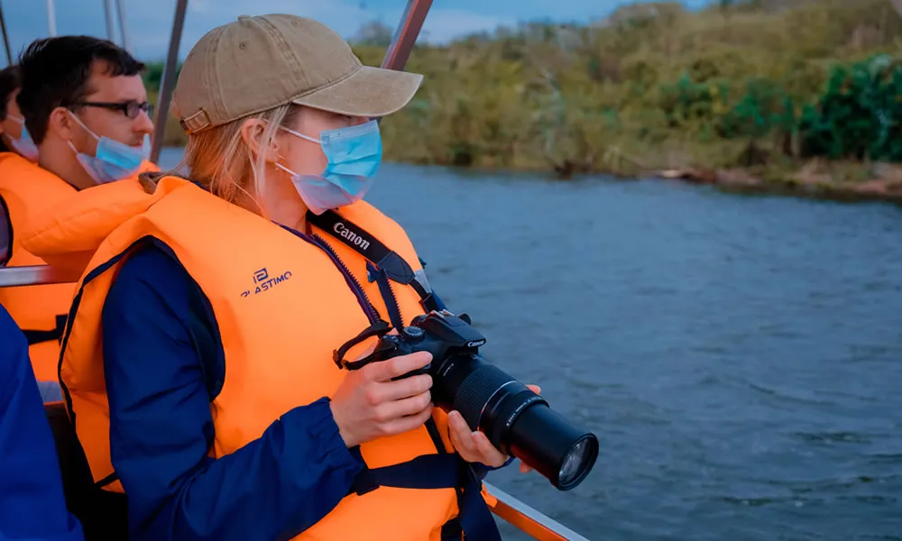 Tourist taking pictures on a boat at Lake Ihema